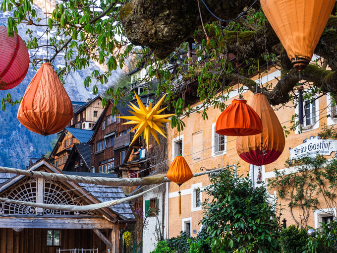 Colorful lanterns hanging from tree at Hallstatt restaurant.