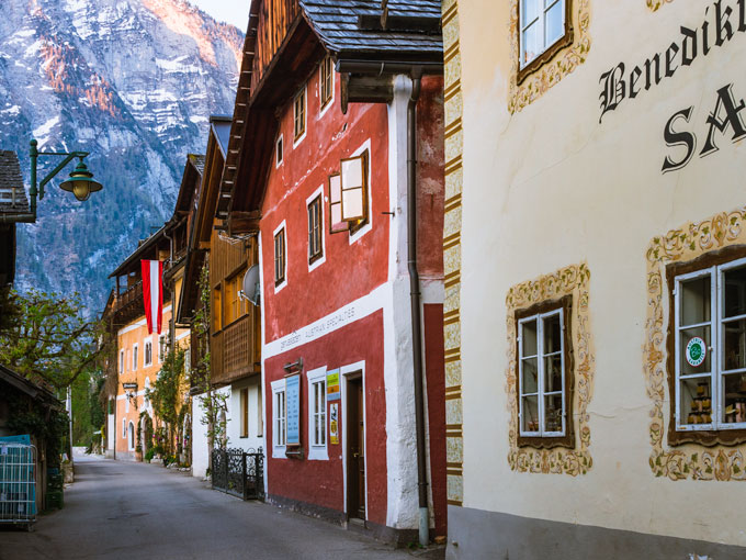 Colorful houses lining the street with mountain view at the end.