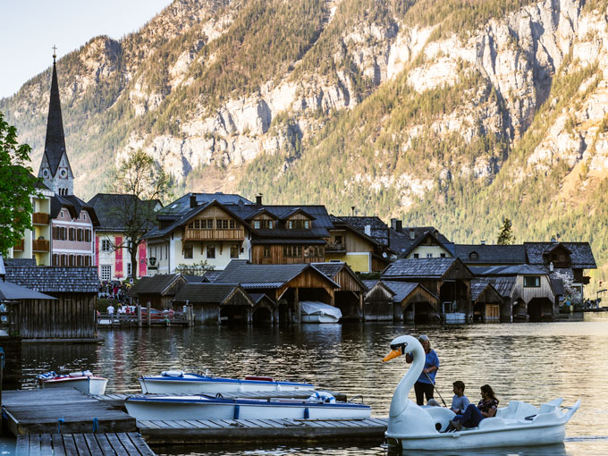 Hallstatt swan boat docked along lake.