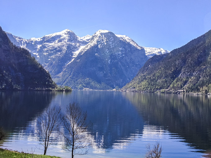 Mountain lake view from train window en route from Salzburg to Hallstatt day trip.