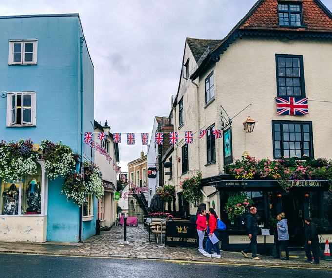 Windsor Village pub and cobbled street, with people visiting on a UK self drive holiday.