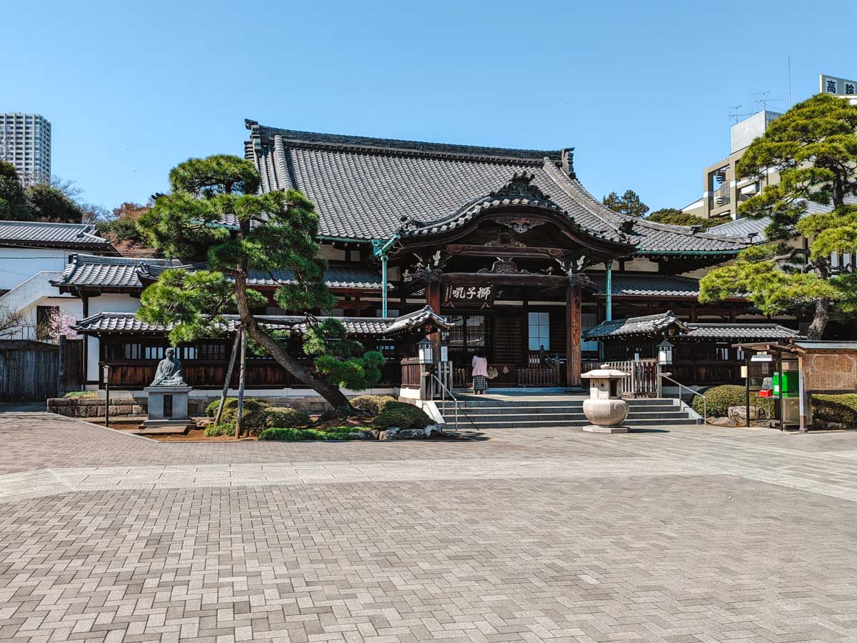 Front view of Sengaku-ji temple with traditional Japanese wooden architecture and roof.