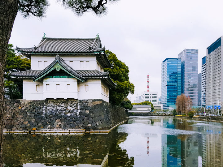 Tokyo Imperial Palace with view of pond and skyscrapers, a popular destination for Japan solo travel.