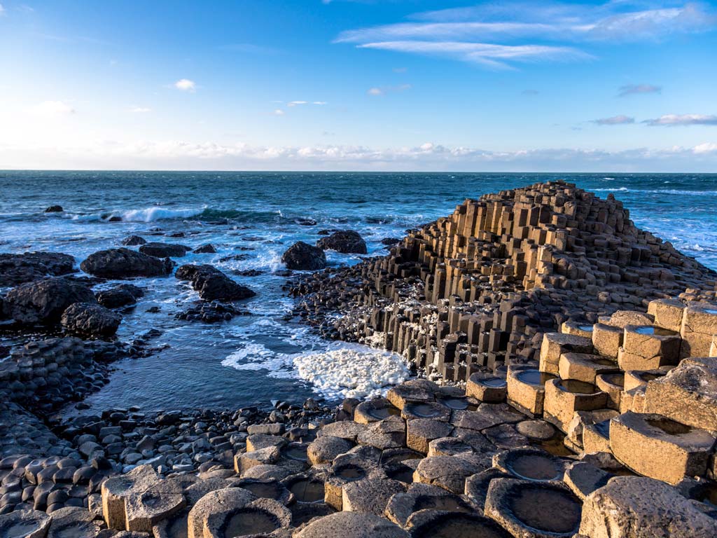 Basalt columns of Ireland's Giant's Causeway sticking out into the ocean.