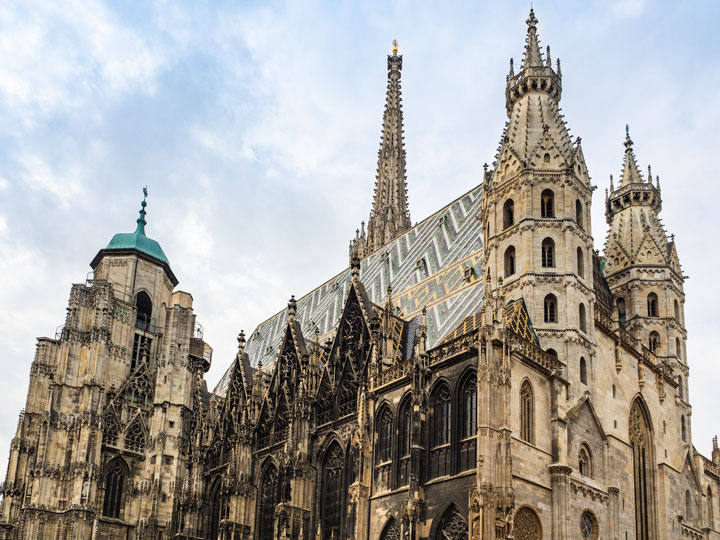 St. Stephen's Cathedral exterior with towers and colorful tiled roof.