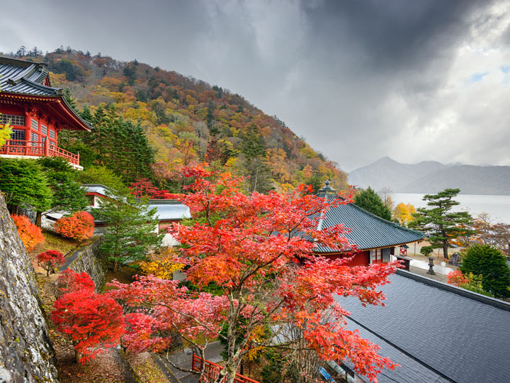 Nikko shrine with view of lake and red Japanese maples, a great option for traveling to Japan alone.