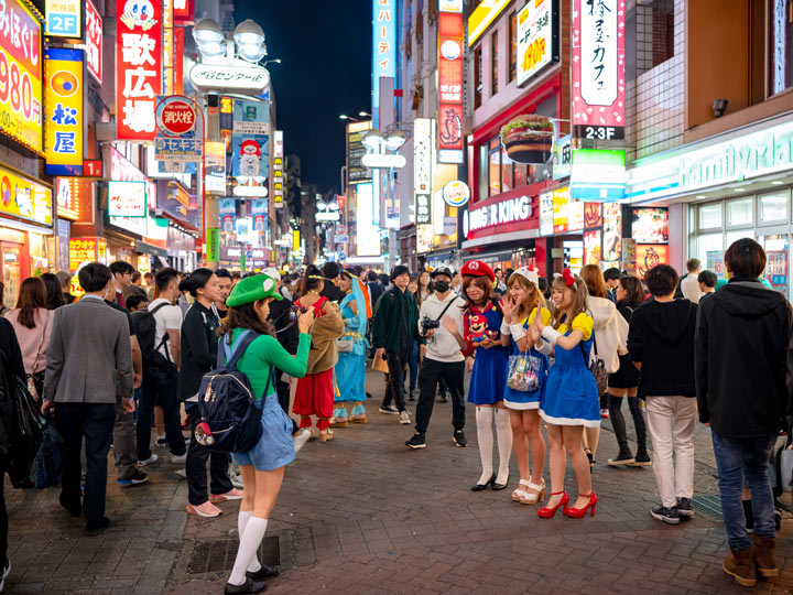 People dressed in cosplay costumes getting photo taken in Akihabara Tokyo.